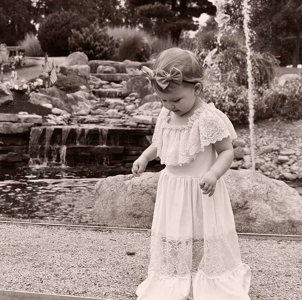 Oaklyn is registered to the contest to win money with this photo: black_and_white, child, day_dress, eyewear, facial_expression, fun, grass, hairstyle, happy, monochrome, monochrome_photography, people_in_nature, person, plant, sleeve, standing, style, toddler, tree, vintage_clothing
