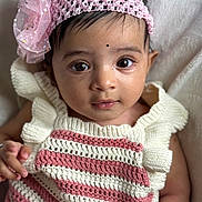 Isabel is registered to the contest to win money with this photo: baby, infant, child, face, headband, pink, white, knitted_clothing, striped_clothing, flower_accessory, blanket, portrait, cute, closeup, young_child, indoors, soft_lighting, skin, eyes, person