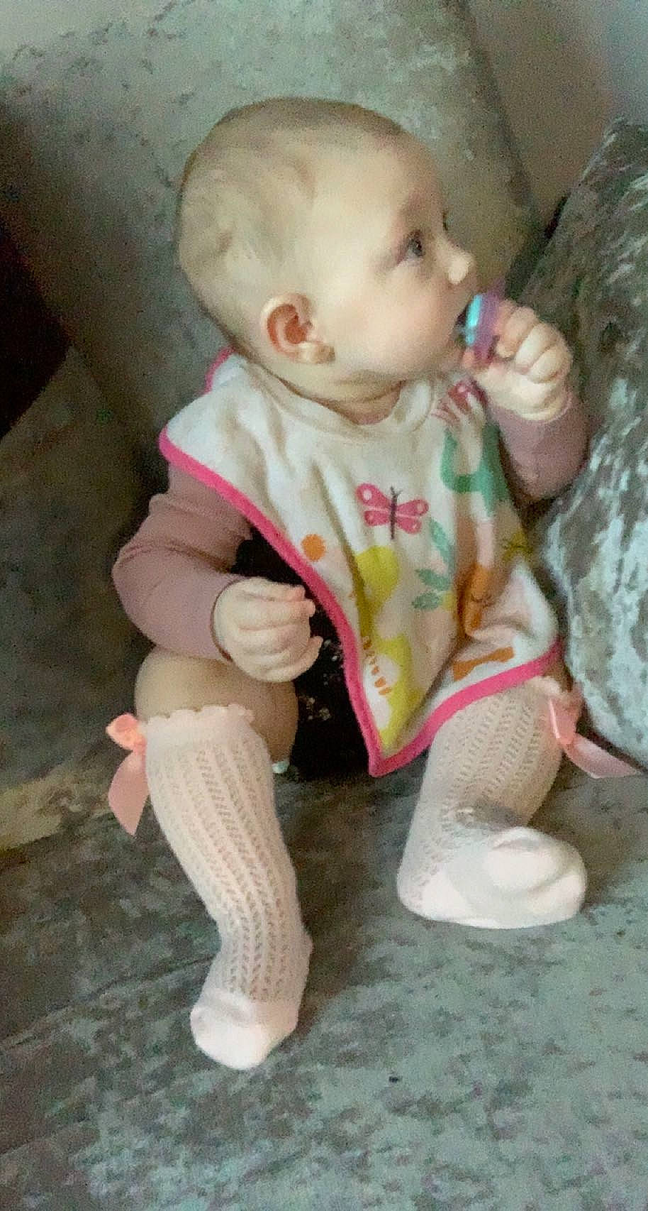 Isla-mae is registered to the contest to win money with this photo: baby, baby_toddler_clothing, cheek, child, comfort, flooring, foot, grass, human_leg, knee, lip, nose, person, pink, sitting, skin, sleeve, sock, toddler, toy