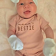 Nova joined the competition — help win amazing prizes! baby, infant, headband, bow, pink_clothing, mittens, tongue_out, winking, lying_down, blanket, cute, smiling, child, soft_texture, cozy, portrait, apparel, one_person, closeup, adorable