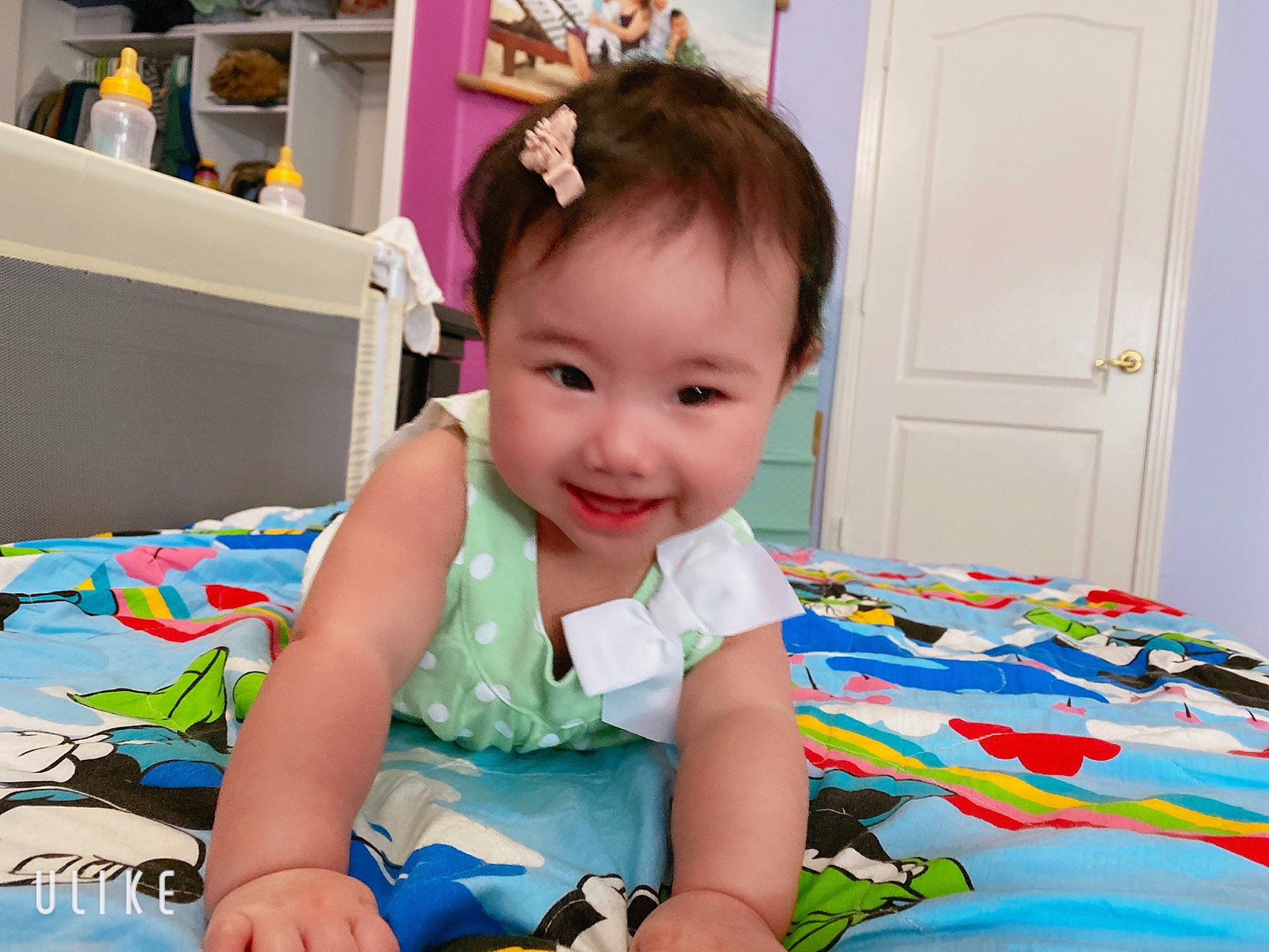 Holly is registered to the contest to win money with this photo: baby, baby_products, baby_toddler_clothing, child, ear, joy, neck, pattern, person, play, product, room, sitting, skin, smile, t_shirt, toddler, toy, tummy_time