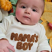 Archer joined the competition — help win amazing prizes! baby, infant, child, face, hands, clothing, shirt, text, blanket, pumpkin, pinecone, autumn, fall, cozy, cute, portrait, indoor, soft, decor, lying_down