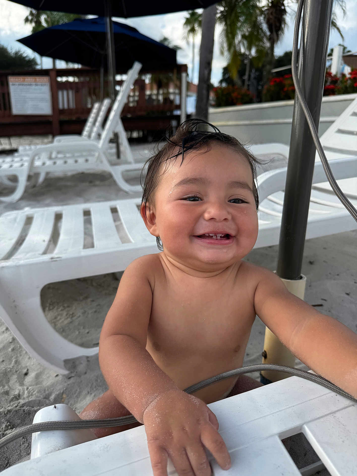 Ian Emmanuel joined the competition — help win amazing prizes! toddler, child, smile, beach, sand, umbrella, lounge_chair, outdoor, happy, sunny, water_droplets, palm_tree, vacation, summer, playful, bare_chest, sunshade, holiday, closeup, fun