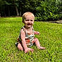 baby, child, grass, outdoor, greenery, smile, sunlight, nature, trees, bushes, happy, sitting, romper, blonde_hair, person, portrait, summer, cute, innocence, playful