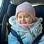 toddler, child, car_seat, winter_clothing, knit_hat, scarf, jacket, smile, blue_eyes, seatbelt, indoor, car_interior, warm_clothing, cute, happy, portrait, baby, sitting, child_protection, cozy