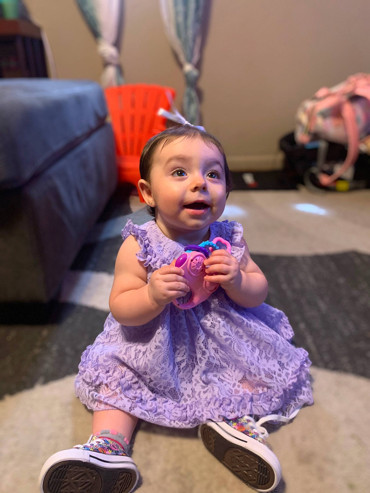 Amelia is registered to the contest to win money with this photo: baby_toddler_clothing, blue, child, couch, event, floor, flooring, fun, happy, leisure, magenta, person, pink, purple, shoe, skin, snapshot, sneakers, toddler, walking_shoe