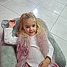 Olivia a rejoint le concours — aidez-le/la à gagner de superbes lots ! child, girl, plush_chair, pink_skirt, fur_vest, blonde_hair, white_sweater, smile, indoor, tile_floor, cute, relaxing, portrait, fashion, childhood, happy, furniture, cozy, playful, casual