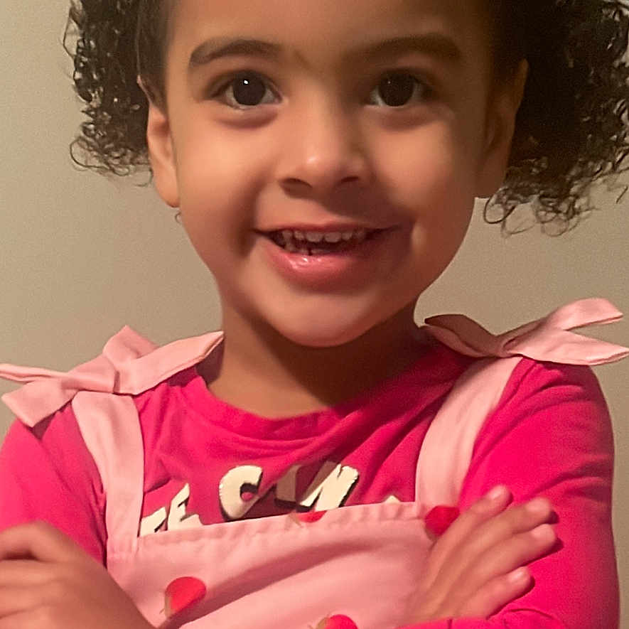 Bianca is registered to the contest to win money with this photo: bodypart, child, clothing, dress, face, female, finger, girl, hand, happy, head, longsleeve, mouth, person, photography, portrait, sleeve, smile, teeth, text