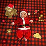 Bastien participe au concours pour gagner de l'argent avec cette photo : baby, celebration, child, christmas, christmas_ornaments, cute, festive, floor_tiles, holiday, holiday_decor, infant, lying_down, newborn, plaid_blanket, red_hat, santa_claus_costume, seasonal, smiling_face, teddy_bear, wooden_sign