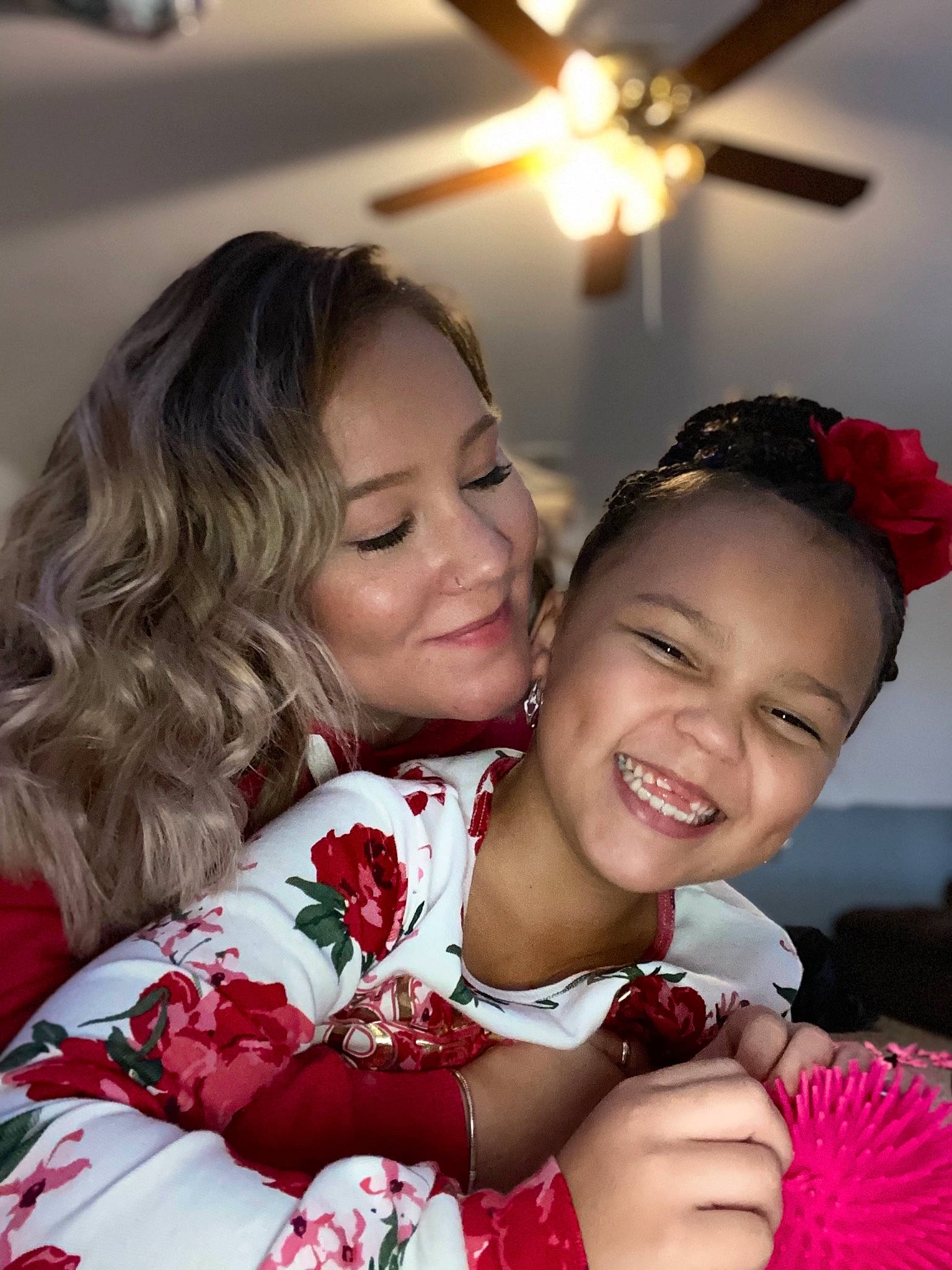 Mila is registered to the contest to win money with this photo: beauty, ceiling_fan, child, dress, event, eye, friendship, fun, gesture, hairstyle, happy, jewellery, joy, mechanical_fan, organ, person, petal, pink, skin, smile