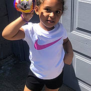 Evii joined the competition — help win amazing prizes! black_shorts, bracelet, cartoon, casual, child, concrete, daylight, door, face, hand, mouse, outdoor, person, playful, smiling, standing, sunlight, toy, white_tshirt, young