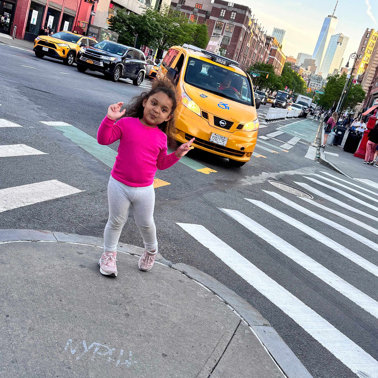 Evii is registered to the contest to win money with this photo: car, child, city, clothing, face, female, footwear, girl, head, intersection, neighborhood, pants, pedestrian, person, photography, road, shoe, tarmac, transportation, vehicle