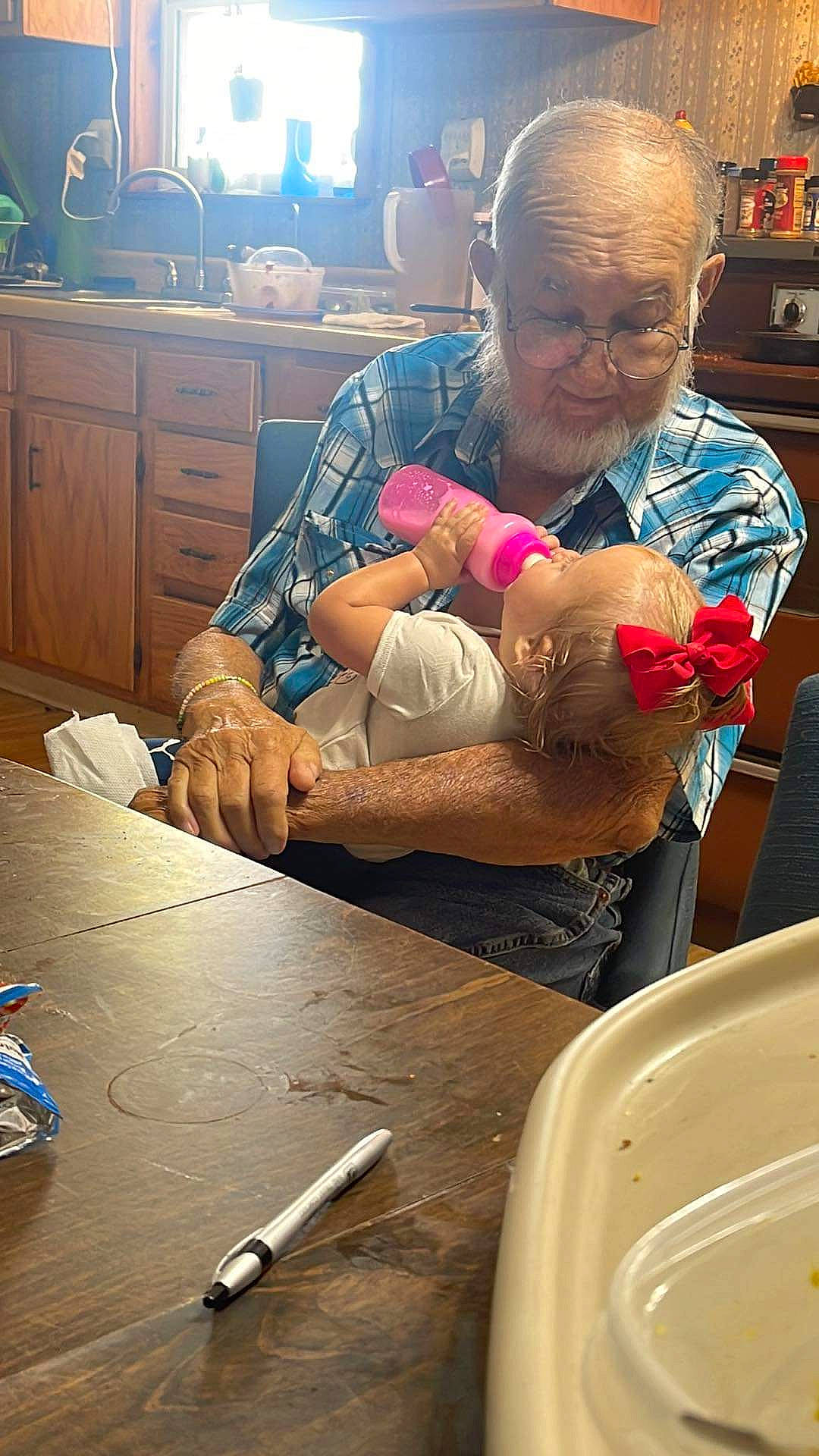 River is registered to the contest to win money with this photo: baby, cabinetry, child, comfort, cooking, drawer, event, eyewear, finger, fun, hand, head, person, photograph, room, skin, snapshot, table, toddler, vision_care