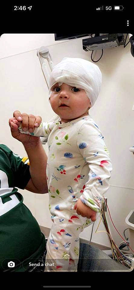 River joined the competition — help win amazing prizes! arm, baby, baby_products, baby_toddler_clothing, child, finger, gesture, hand, happy, headwear, linens, person, personal_protective_equipment, room, sitting, skin, sleeve, t_shirt, textile, thumb