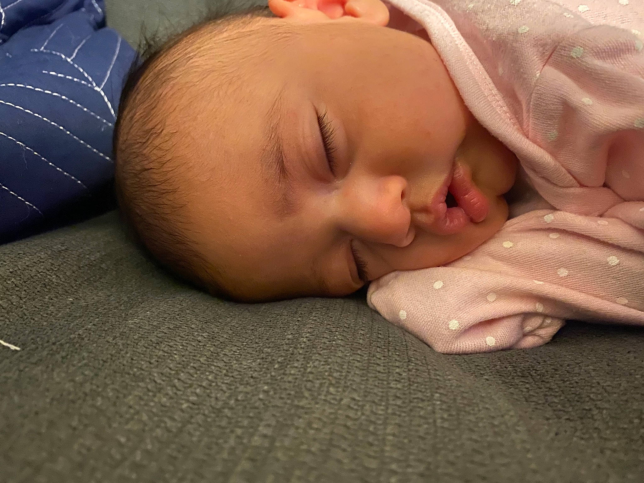 Reyna is registered to the contest to win money with this photo: baby, baby_toddler_clothing, cheek, comfort, eye, eyebrow, finger, flooring, gesture, head, human_body, linens, lip, mouth, neck, nose, person, skin, sleeve, toddler