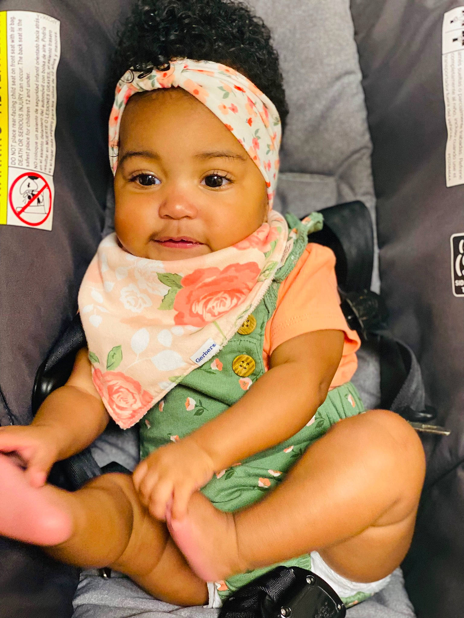 Saige is registered to the contest to win money with this photo: baby, baby_carriage, baby_toddler_clothing, cap, car_seat, cheek, comfort, eye, face, fun, happy, headgear, headwear, lap, mouth, nail, person, seat_belt, skin, sleeve