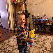 Eli joined the competition — help win amazing prizes! child, boy, smile, plaid_shirt, jeans, boots, bubble_blower, bubbles, carpet, living_room, cabinet, dining_table, chairs, decorations, wood_floor, door, fan, toy, indoor, happy