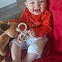 Lenny participe au concours pour gagner de l'argent avec cette photo : baby, child, couch, cute, face, foot, giraffe_teether, hand, happy, home, indoor, infant, orange_shirt, person, plush_toy, red_blanket, sitting, smiling, toy, white_shorts