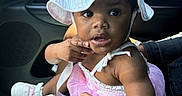 Privilege is registered to the contest to win money with this photo: baby, car_interior, casual, child, curious, cute, family, girl, hand, hat, indoor, infant, person, pink_dress, portrait, seat, shoes, sitting, summer_hat, wide_eyes