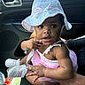 baby, car_interior, casual, child, curious, cute, family, girl, hand, hat, indoor, infant, person, pink_dress, portrait, seat, shoes, sitting, summer_hat, wide_eyes