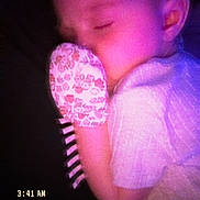 Emorie is registered to the contest to win money with this photo: baby, sleeping, mittens, purple_light, closeup, face, infant, child, retro, timestamp, text_overlay, soft_light, peaceful, portrait, night, clothing, hand, cute, sleep, indoors