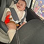 Lyana a rejoint le concours — aidez-le/la à gagner de superbes lots ! toddler, child, car_seat, toy, crab_toy, car_interior, window, sunshade, fish, seatbelt, smiling, happy, clothing, sock, head, face, seat, vehicle, baby, indoor
