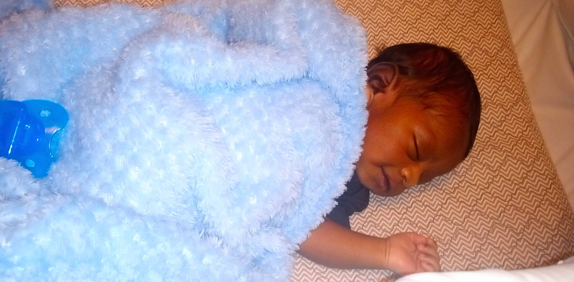 Cadence is registered to the contest to win money with this photo: baby, baby_products, baby_sleeping, baby_toddler_clothing, bedding, bedtime, child, cloud, comfort, electric_blue, fashion_accessory, flooring, fun, fur, happy, linens, person, room, textile, toddler