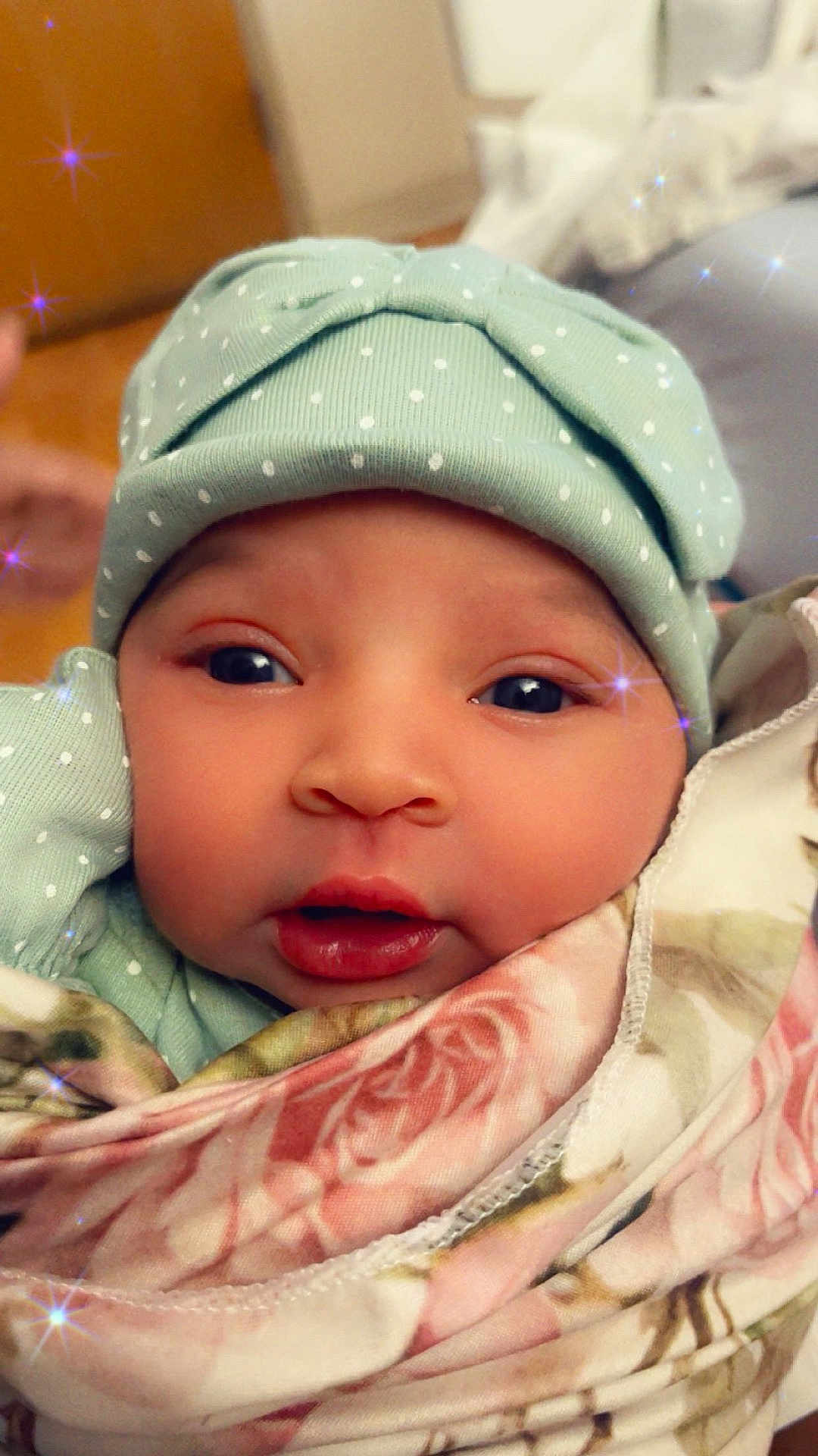 Winter is registered to the contest to win money with this photo: baby, infant, face, hat, polka_dot, blanket, floral, closeup, cute, eyes, skin, mouth, cheeks, headwear, soft, indoors, portrait, sparkles, warm, cozy
