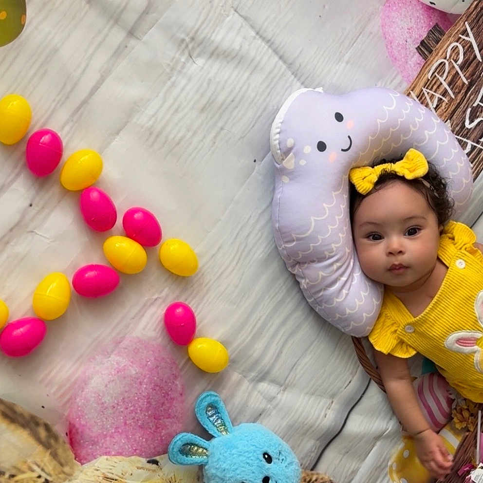 Alina Aurora is registered to the contest to win money with this photo: baby, child, yellow_outfit, bunny_design, plush_toy, cloud_pillow, colorful_eggs, easter_theme, festive, happy_easter_sign, blanket, headband, curly_hair, indoor, holiday, celebration, smiling_pillow, toy_bunny, basket, bright_colors