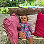 Charli participe au concours pour gagner de l'argent avec cette photo : baby, child, outdoor, bench, pillow, patterned_clothing, smiling, garden, greenery, flower, foot, happy, cushion, summer, nature, daylight, relaxing, cute, infant, portrait