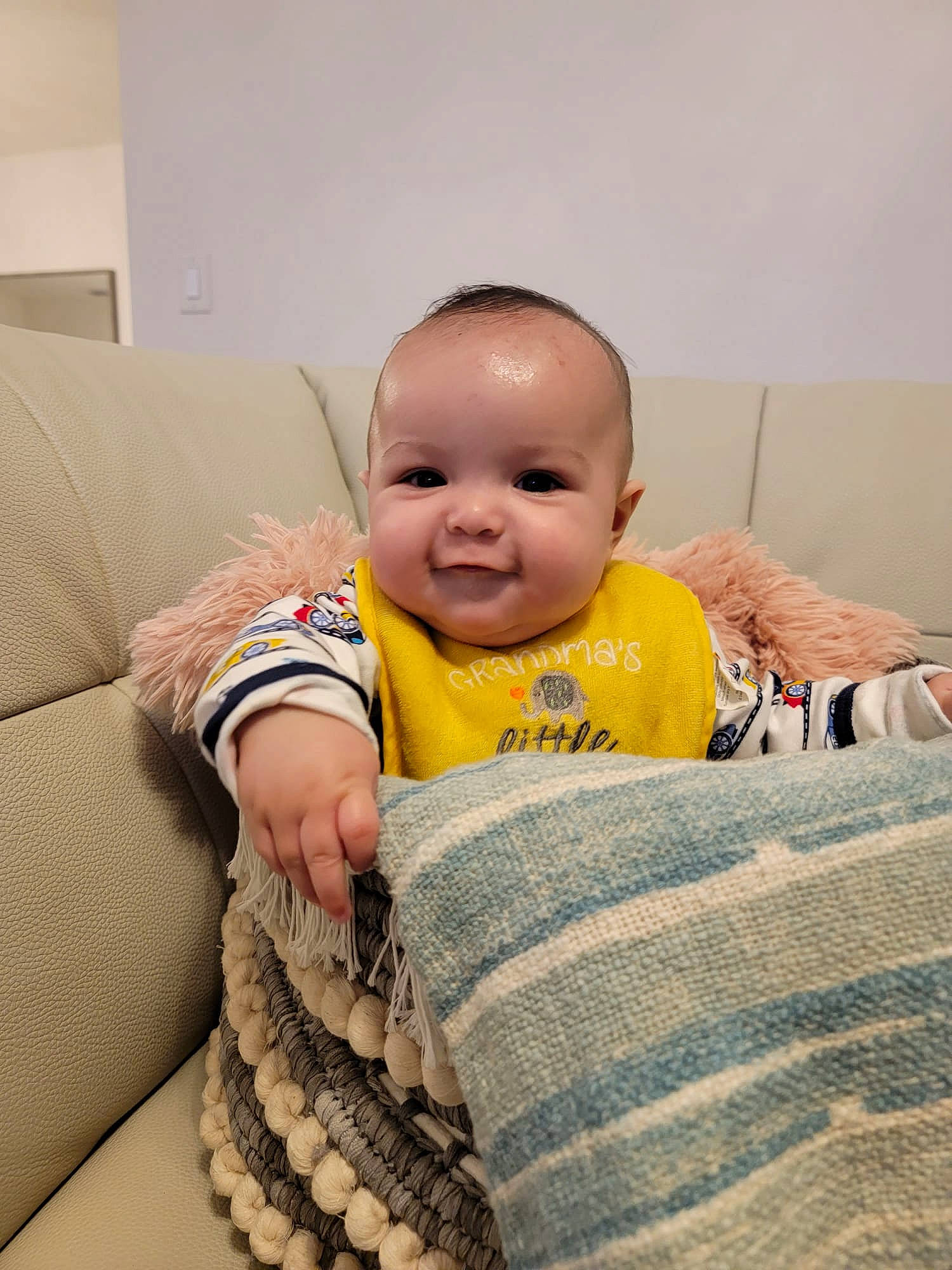 Isaac joined the competition — help win amazing prizes! baby, baby_toddler_clothing, cheek, child, comfort, couch, eye, flooring, happy, head, human_body, iris, joy, nose, person, sitting, skin, sleeve, smile, thumb