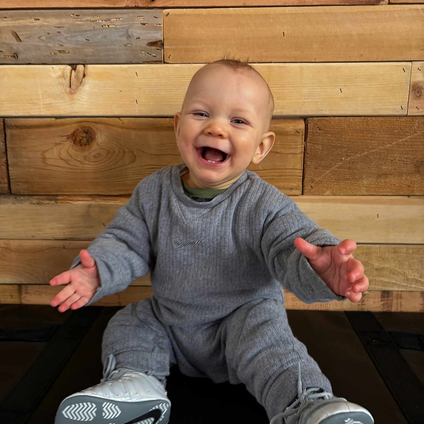 Greylin joined the competition — help win amazing prizes! baby, babylaughing, bodypart, clothing, face, finger, footwear, hand, happy, hardwood, head, pants, person, photography, plywood, portrait, shoe, sitting, sneaker, wood