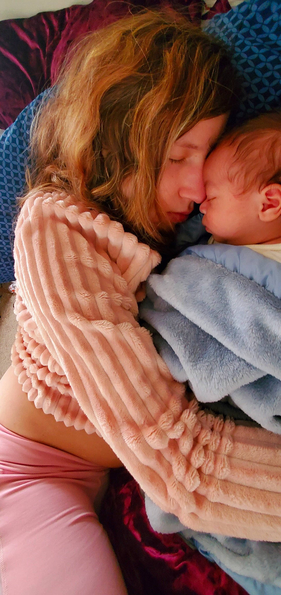 Avery is registered to the contest to win money with this photo: arm, baby, beauty, cheek, child, comfort, face, gesture, hair, happy, head, human, lip, mouth, organ, outerwear, person, pink, sleeve, textile