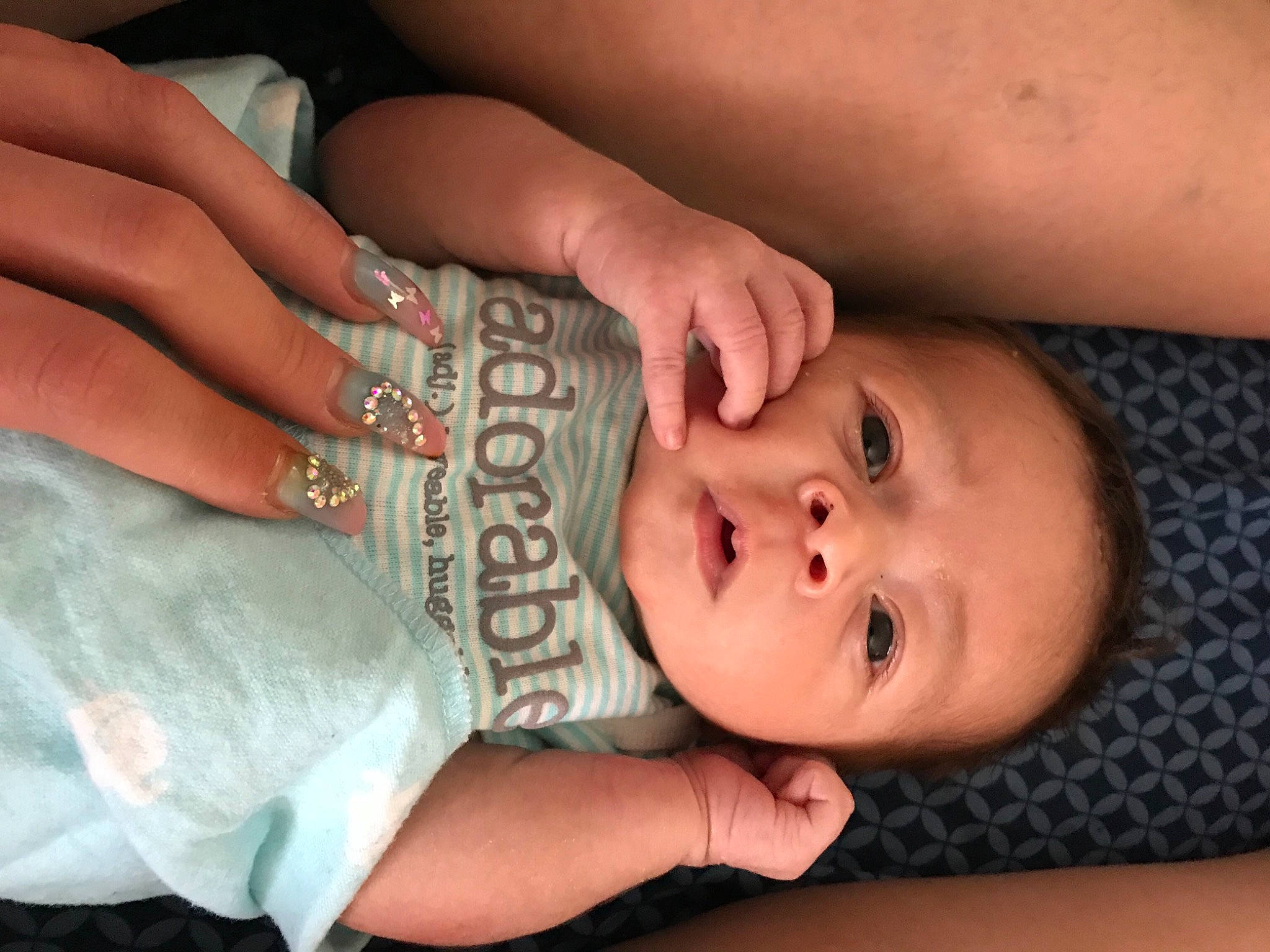 Avery is registered to the contest to win money with this photo: baby, baby_toddler_clothing, cheek, chin, eye, eyebrow, eyelash, finger, gesture, hand, head, human_body, iris, joint, lip, mouth, neck, nose, person, skin