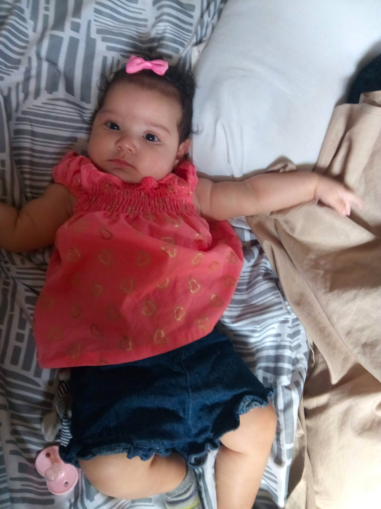 Emelia is registered to the contest to win money with this photo: abdomen, arm, baby, black_hair, cheek, child, finger, leg, person, pink, product, sitting, skin, thigh, toddler, trunk