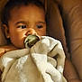 Jayza participe au concours pour gagner de l'argent avec cette photo : baby, blanket, child, closeup, comfort, cozy, cushion, cute, expression, face, indoor, infant, pacifier, portrait, rest, skin, sleepy, soft_light, warm, young_child