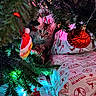 Delilah is registered to the contest to win money with this photo: animal, cat, celebration, christmas_tree, closeup, cozy, curious, decoration, festive, gift_wrap, greenery, holiday_lights, indoor, ornament, pattern, pet, presents, red, tabby, white