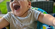Miles joined the competition — help win amazing prizes! baby, babylaughing, bodypart, clothing, face, happy, head, laughing, mouth, outdoorplayarea, outdoors, person, photography, playarea, portrait, smile, t_shirt, teeth, toy, water