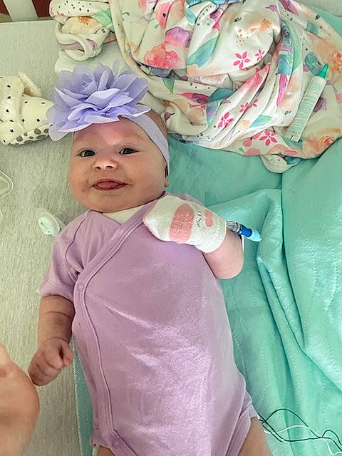 Novalee is registered to the contest to win money with this photo: baby, baby_products, baby_toddler_clothing, cap, child, costume, event, hair_accessory, happy, headgear, headwear, magenta, party_supply, pattern, person, pink, purple, sleeve, smile, t_shirt