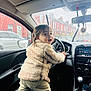 Kenan participe au concours pour gagner de l'argent avec cette photo : baby, car, car_exterior, carmirror, clothing, coat, driving, face, fun, happy, head, pants, person, photography, portrait, sitting, smile, transportation, vacation, vehicle