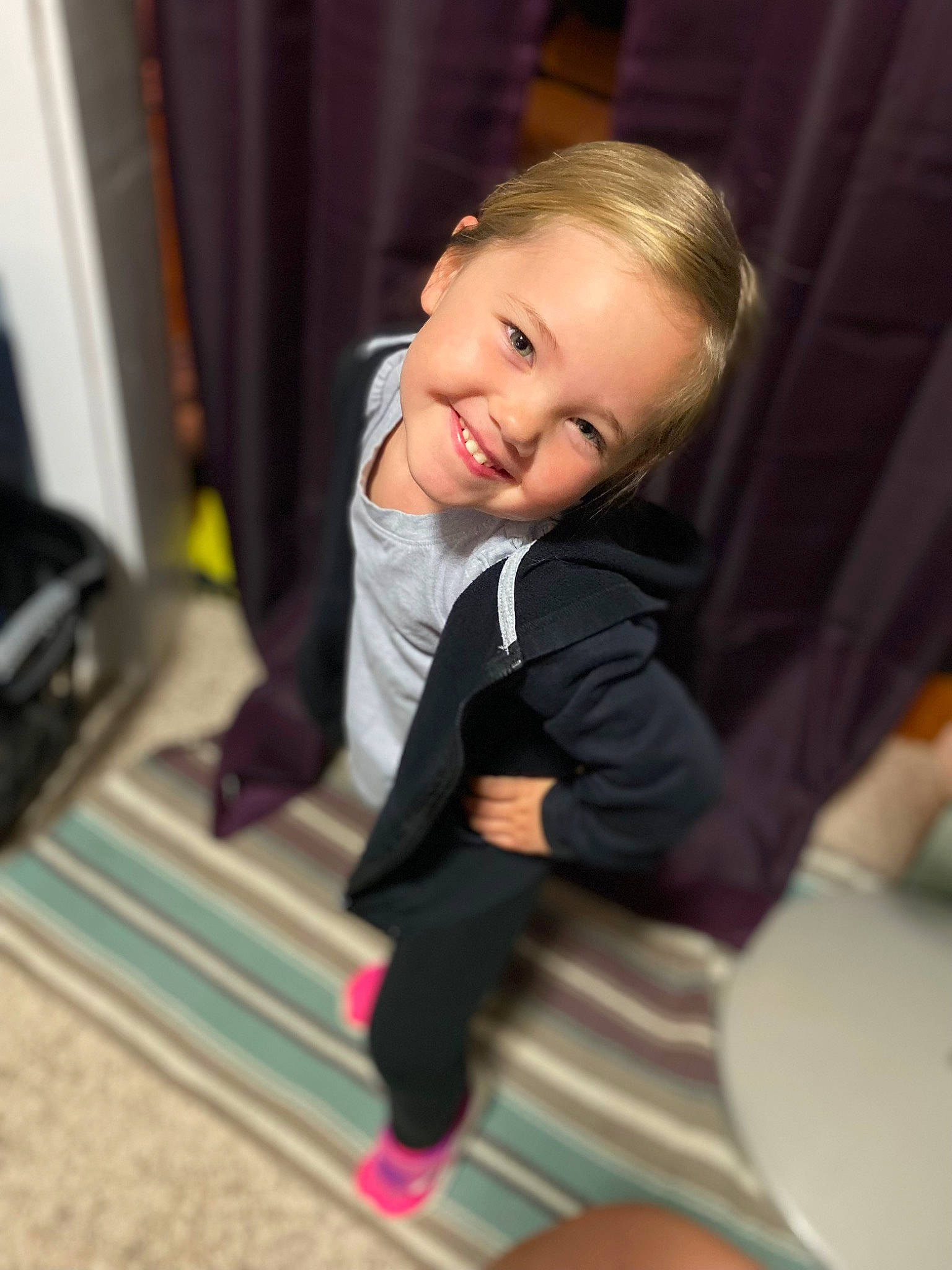 Adalyn joined the competition — help win amazing prizes! baby_toddler_clothing, carpet, cheek, child, comfort, curtain, floor, flooring, formal_wear, fun, hair, happy, hardwood, iris, joy, person, room, sitting, smile, suit