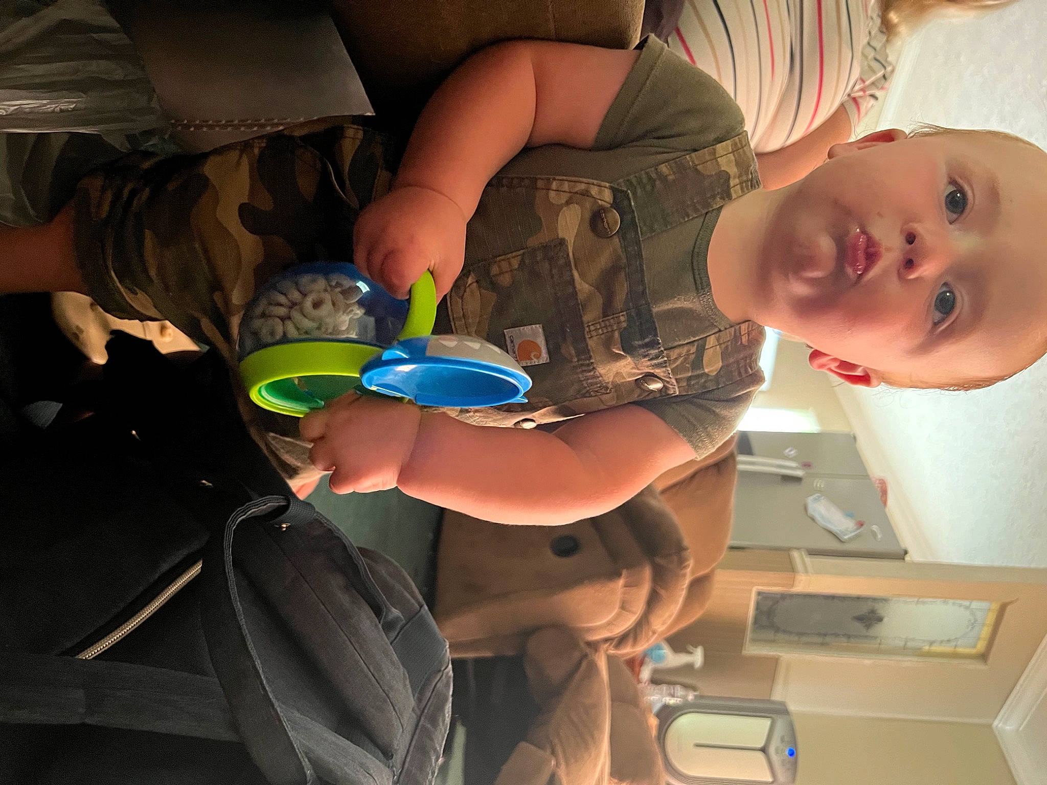 Axel is registered to the contest to win money with this photo: arm, baby, baby_toddler_clothing, child, clothing, elbow, finger, food, fun, hand, happy, human_leg, joint, knee, mouth, nail, person, smile, thigh, toddler