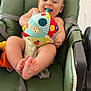 baby, child, colorful, cushion, cute, diaper, fabric, feet, green_chair, happy, indoor, infant, person, playful, room, seat, smiling, soft_toy, toy, young_child