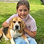 girl, child, dog, beagle, pet, animal, grass, outdoor, smiling, happy, casual_clothing, nature, young, friendship, cute, portrait, daylight, leisure, playing, companionship