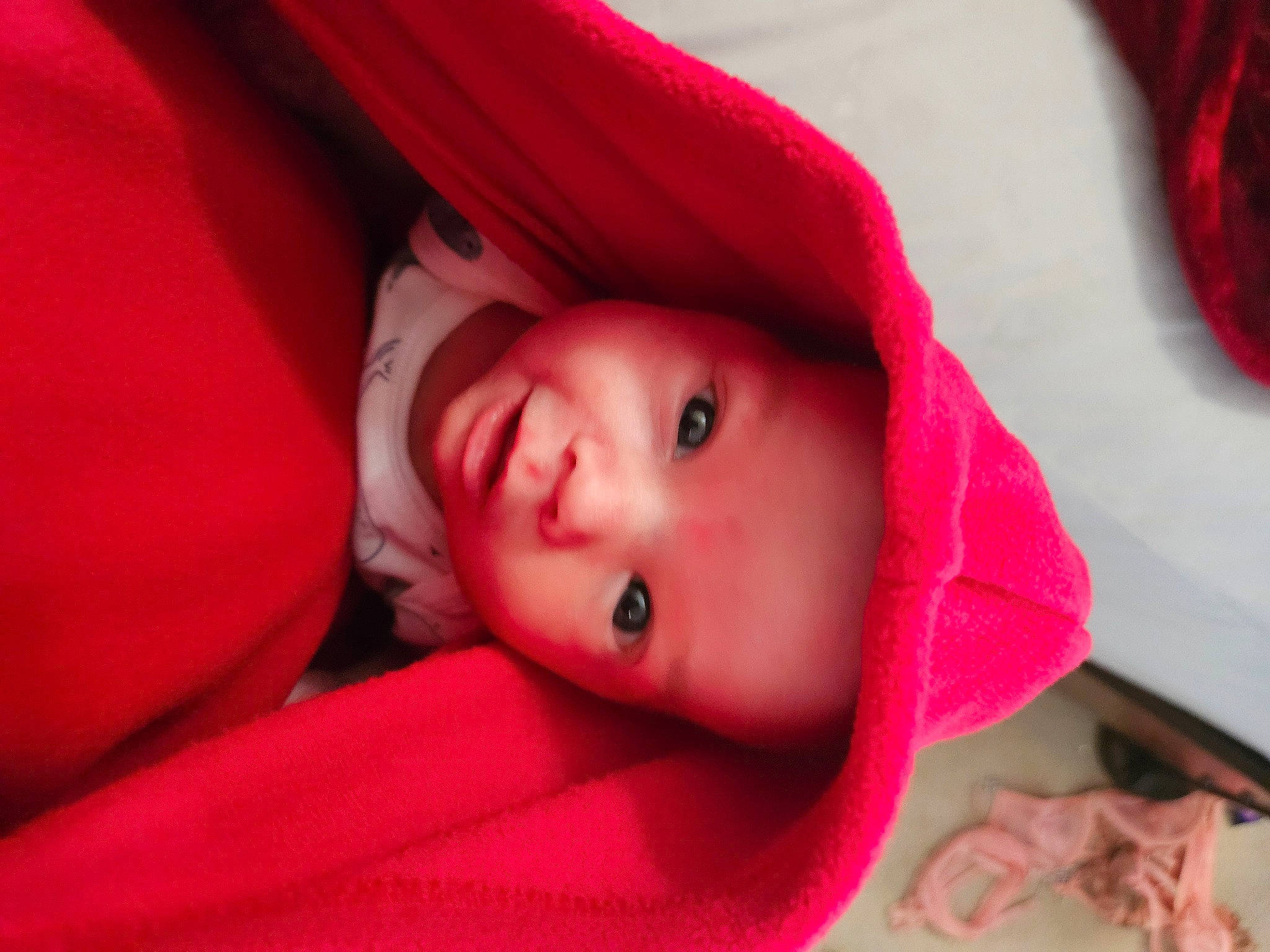 Connor is registered to the contest to win money with this photo: carmine, child, chin, close_up, comfort, eyebrow, eyelash, fashion_accessory, happy, hat, linens, lip, magenta, mouth, nose, person, pink, red, skin, smile