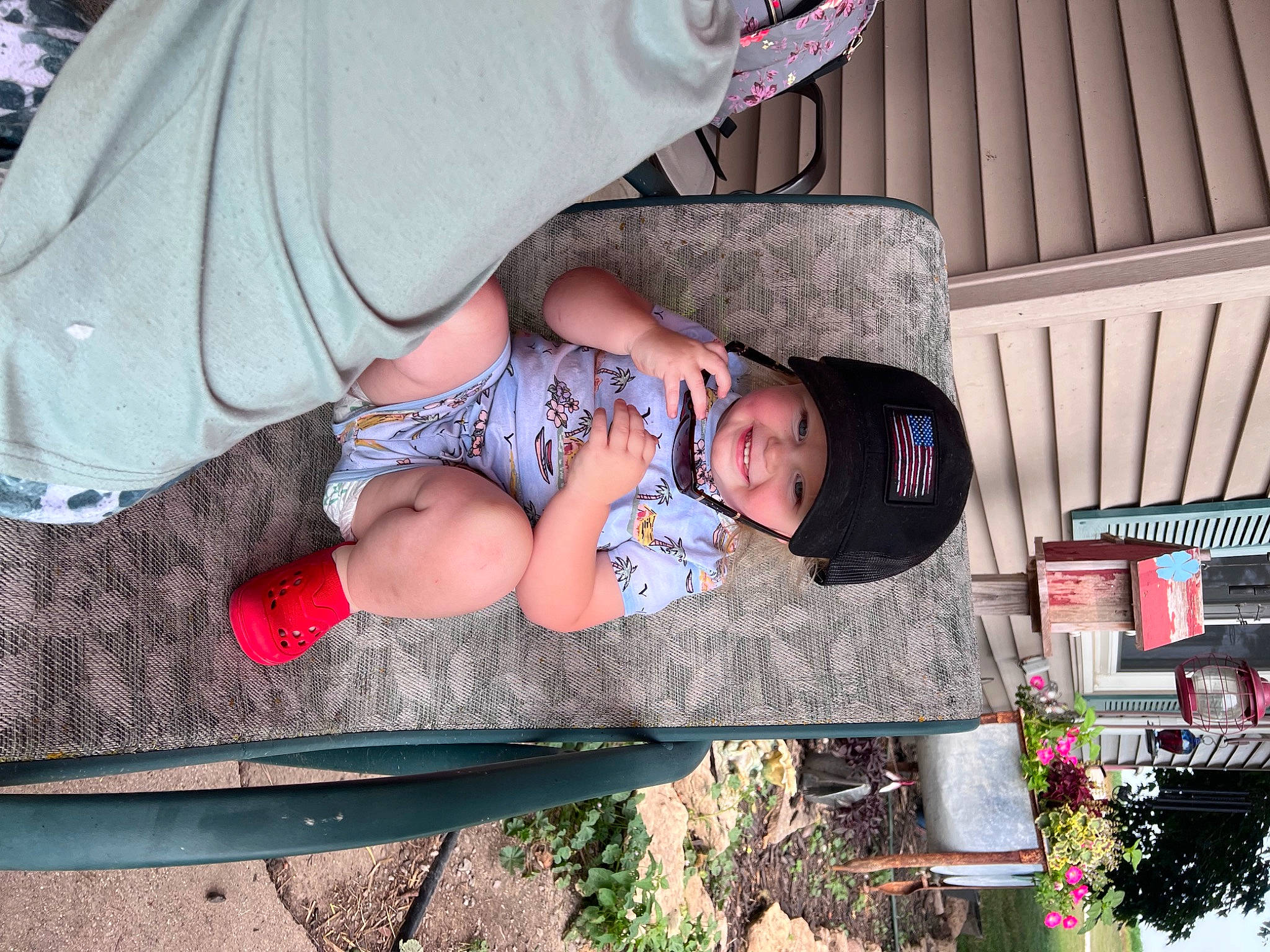 Adalynn joined the competition — help win amazing prizes! baby, baby_products, baby_toddler_clothing, child, comfort, flowerpot, foot, fun, grass, headwear, human_leg, joy, lap, leg, leisure, outdoor_furniture, person, plant, sitting, sunglasses