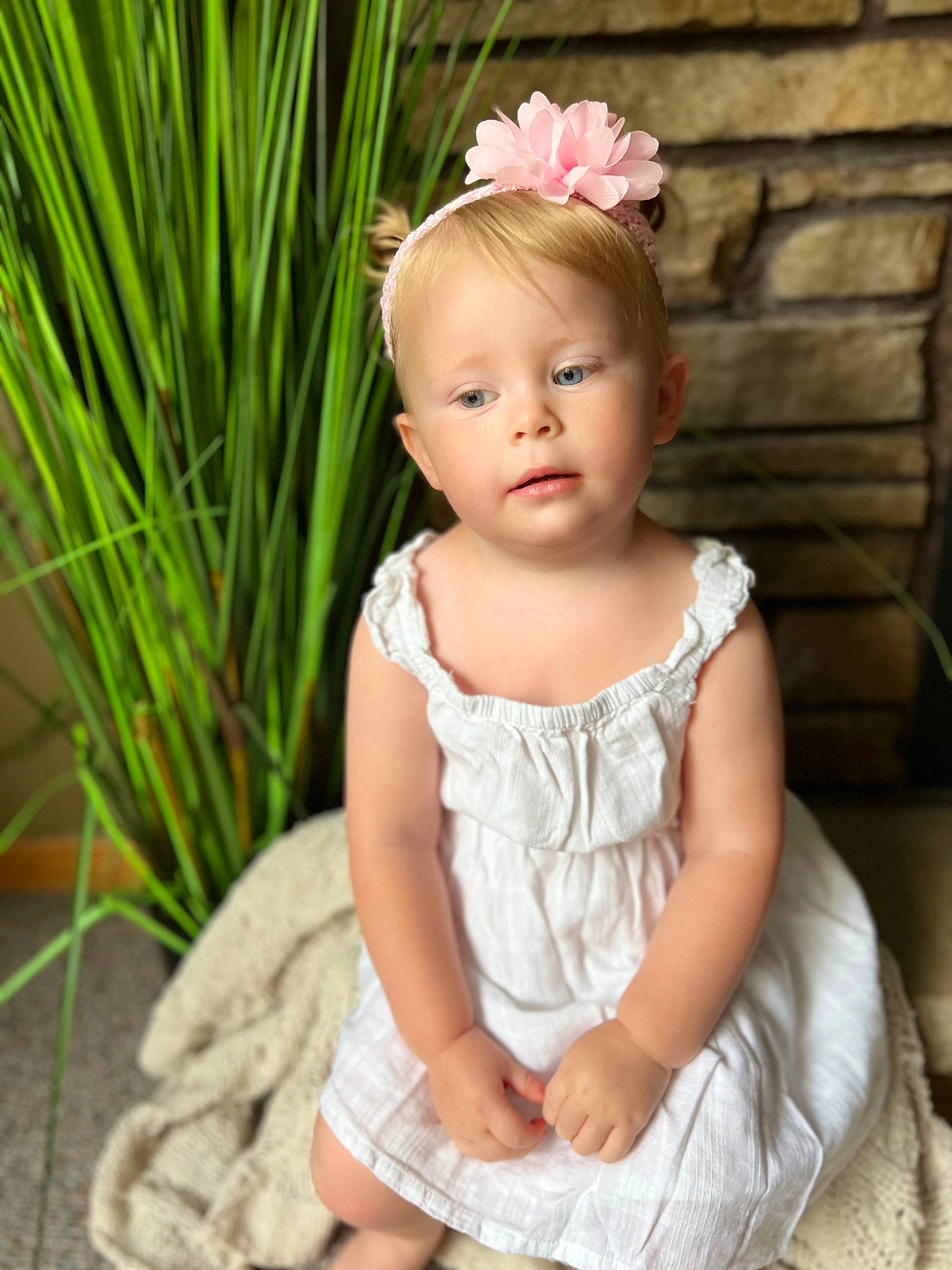 Adalynn is registered to the contest to win money with this photo: baby, baby_toddler_clothing, blond, dress, embellishment, eye, eyelash, face, flash_photography, flower, grass, happy, head, headgear, iris, person, petal, pink, plant, skin