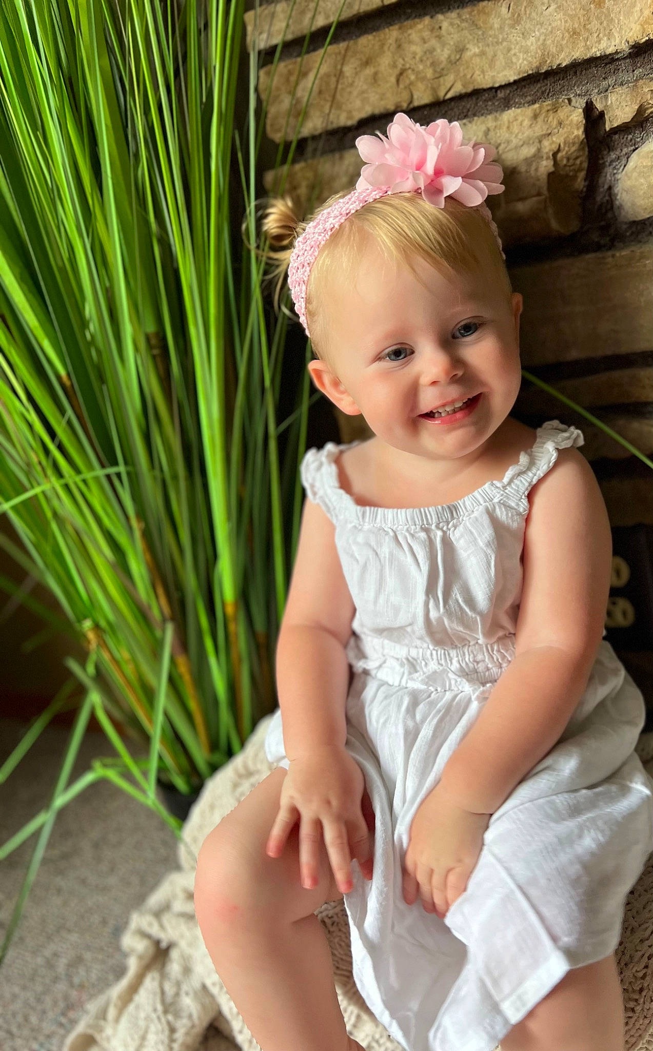 Adalynn is registered to the contest to win money with this photo: baby, baby_toddler_clothing, dress, eye, facial_expression, flash_photography, grass, hair, hairstyle, happy, head, headpiece, human_body, iris, joy, person, pink, plant, shoulder, skin