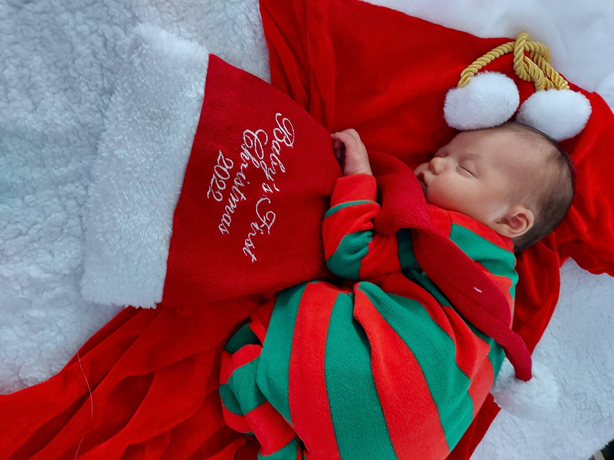 Everly joined the competition — help win amazing prizes! baby, baby_sleeping, baby_toddler_clothing, carmine, christmas, comfort, costume_hat, event, fictional_character, font, hand, happy, hat, head, holiday, linens, pattern, person, sleeve, textile