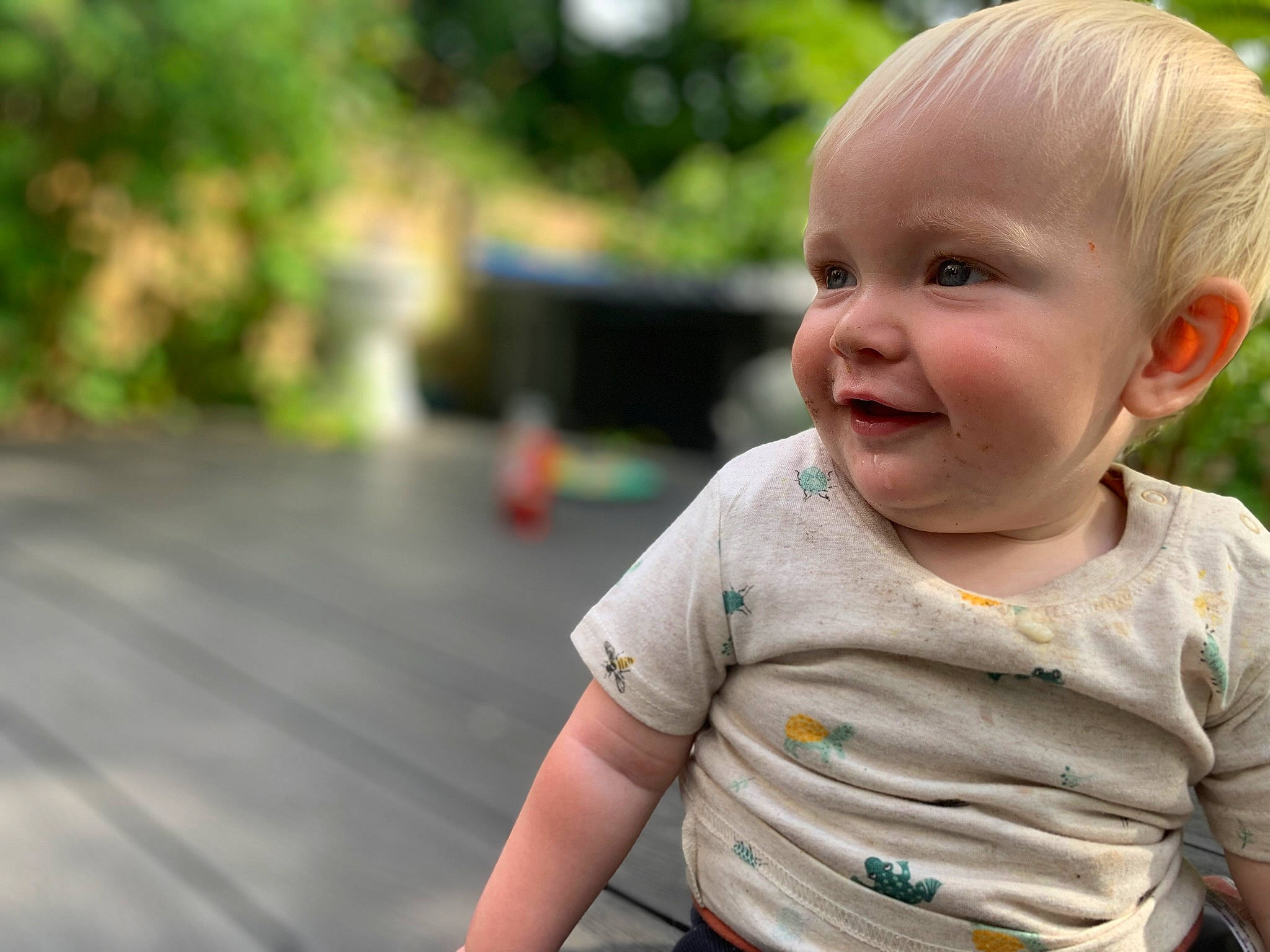 Sonny is registered to the contest to win money with this photo: baby, baby_toddler_clothing, cheek, child, fun, grass, happy, iris, joy, leisure, nose, people_in_nature, person, plant, recreation, skin, sleeve, smile, t_shirt, toddler